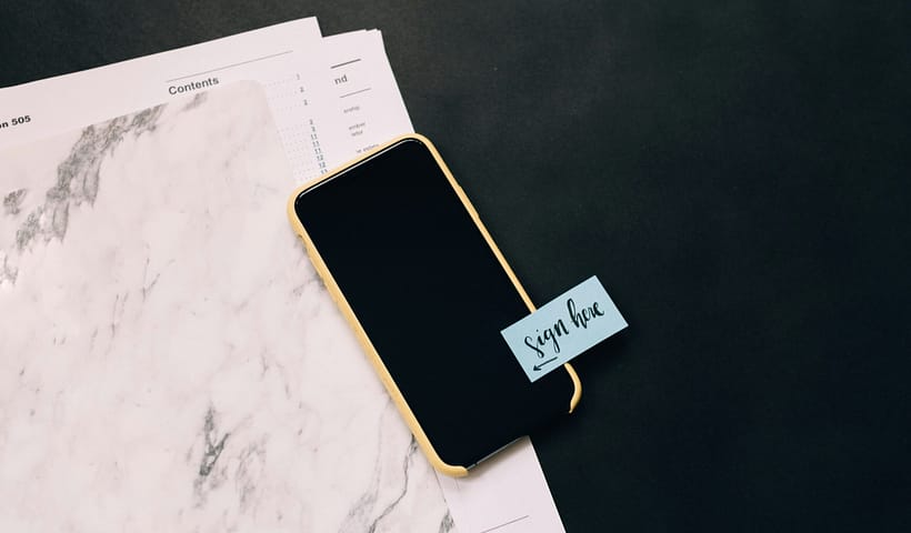 black smartphone on white pad